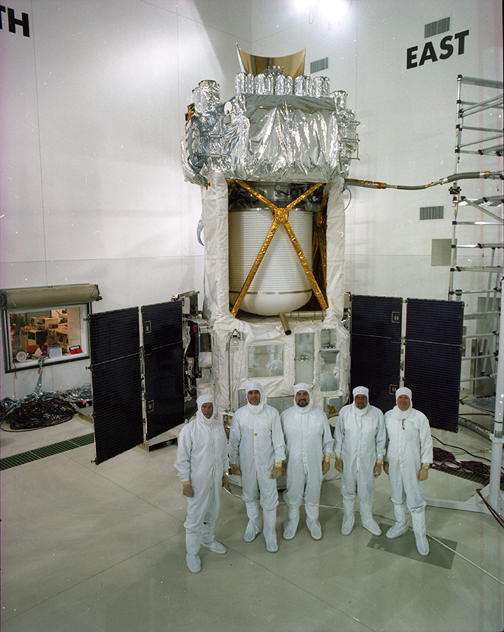 APL engineers stand in front of the massive 5,500-pound Midcourse Space Experiment (MSX)