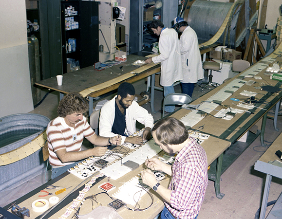 Lab staff members working on arrays in the old Building 12 (one of the Butler Buildings) in 1983