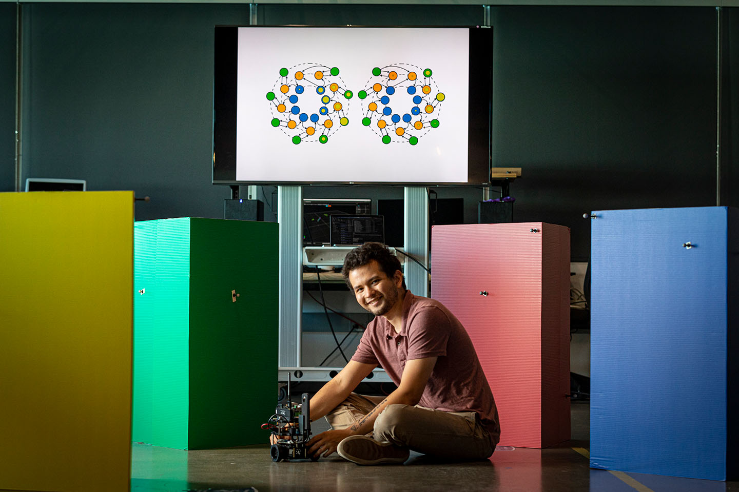 Raphael Norman-Tenazas, neuro-AI researcher, tests a robot navigation strategy inspired by the fruit fly connectome.
