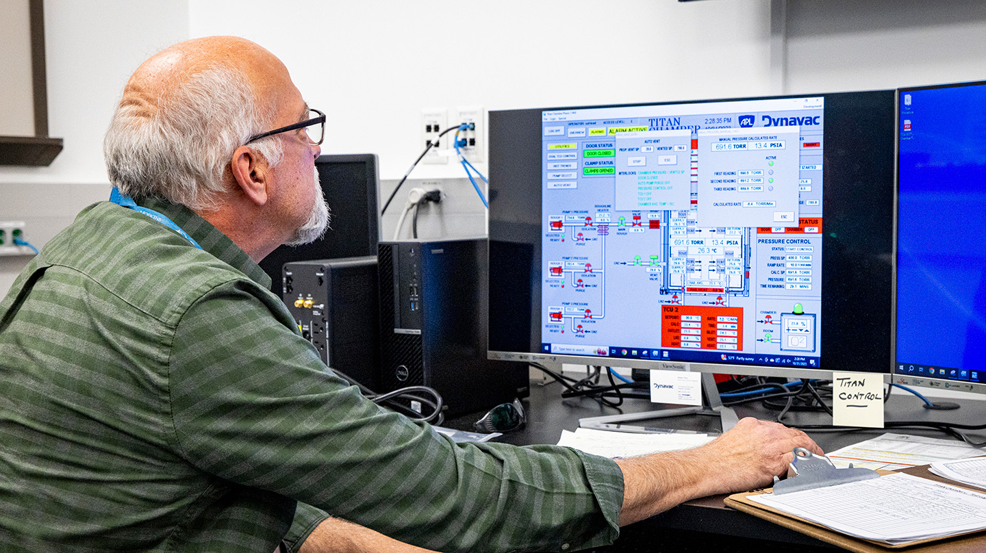 Engineer Andy Webb of APL checks conditions inside the Titan Chamber during its first tests. 