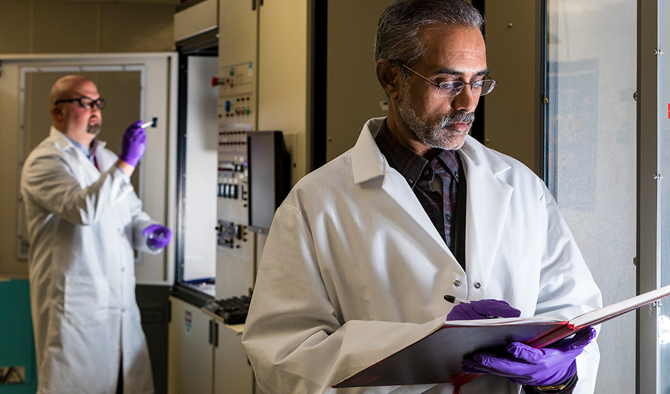 Rama Venkatasubramanian (foreground), shown in APL’s Metal Organic Chemical Vapor Deposition Lab, leads a team of researchers exploring innovative thermoelectric devices.