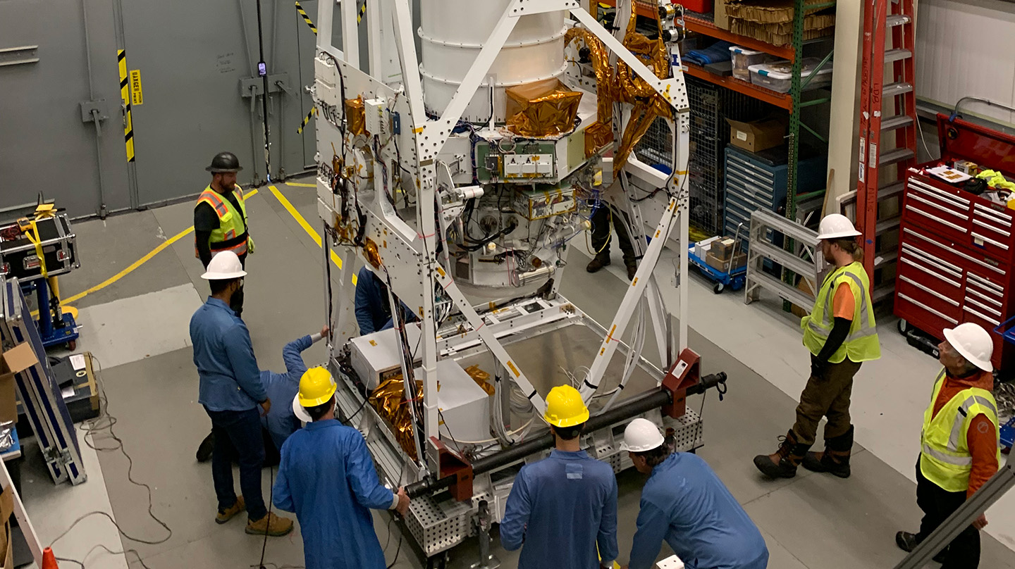 Columbia Scientific Balloon Facility personnel assist the GUSTO team in flipping the observatory from a horizontal to a vertical position