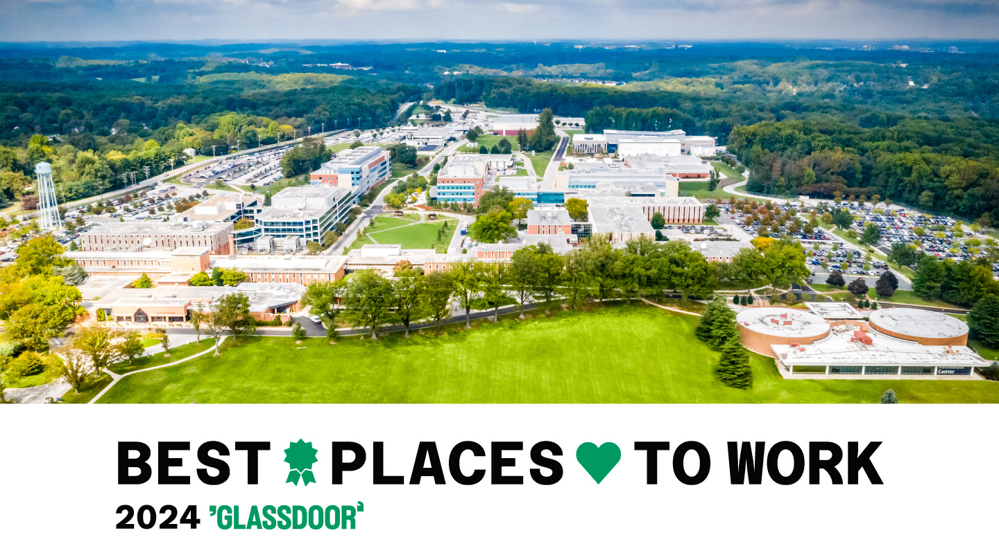 Composite image showing an aerial view of the Johns Hopkins APL campus. A banner underneath reads "Best Places to Work 2024" with the Glassdoor logo.