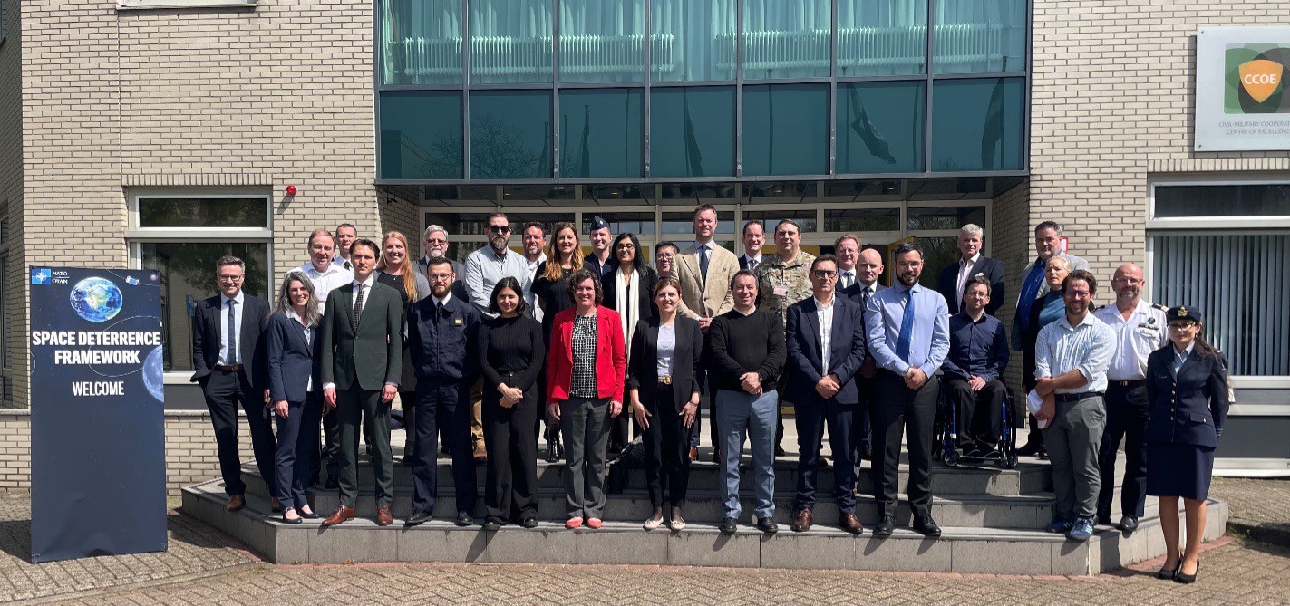 Participants at the Multi-Domain Space Deterrence Framework 2024 wargame stand outside The Hague