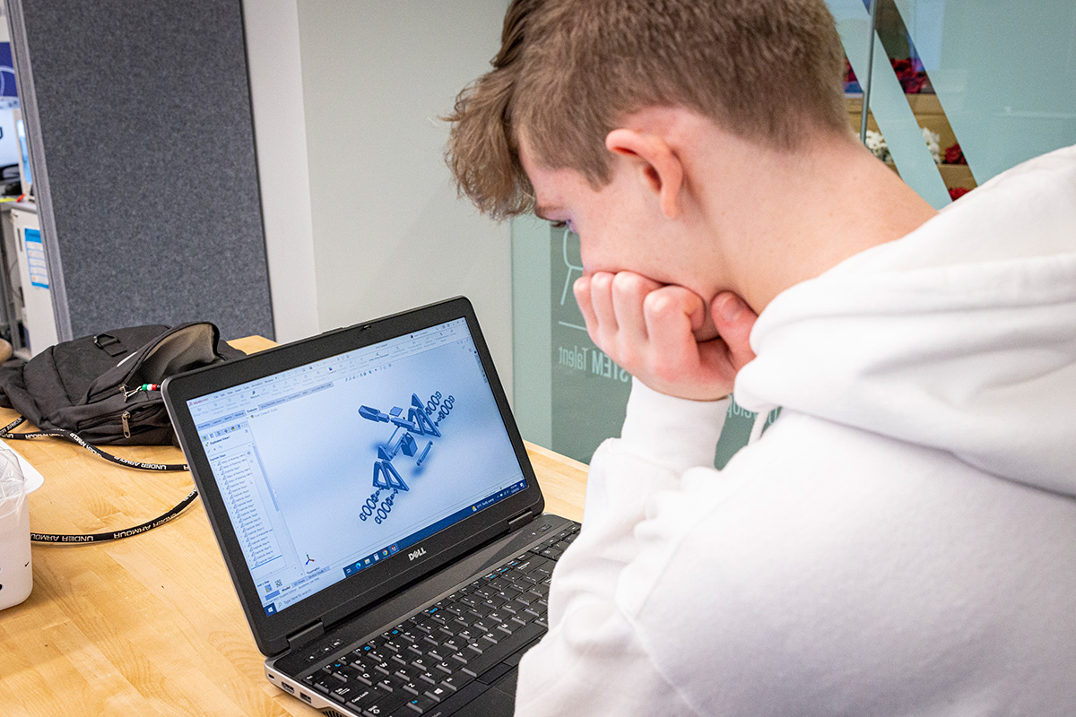 A STEM Academy student reviews a visualization on a laptop
