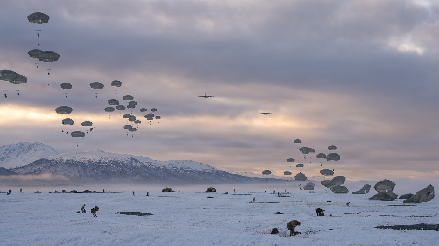 U.S. Army paratroopers assigned to 2nd Infantry Brigade Combat Team (Airborne), 11th Airborne Division, descend during an airborne insertion concluding their part of Arctic Aloha 26 on Malemute Drop Zone at Joint Base Elmendorf-Richardson, Alaska, Nov. 14, 2025. (Credit: U.S. Army/Correy Mathews)