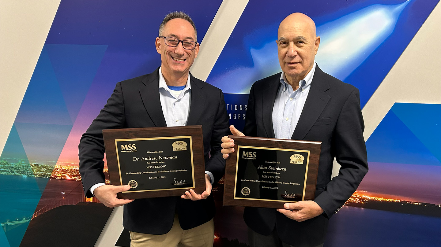 Andrew Newman (left) displays his plaque commemorating his induction as a Military Sensing Symposia Fellow alongside another new fellow, Alan Steinberg of Data Fusion & Neural Networks LLC (right).