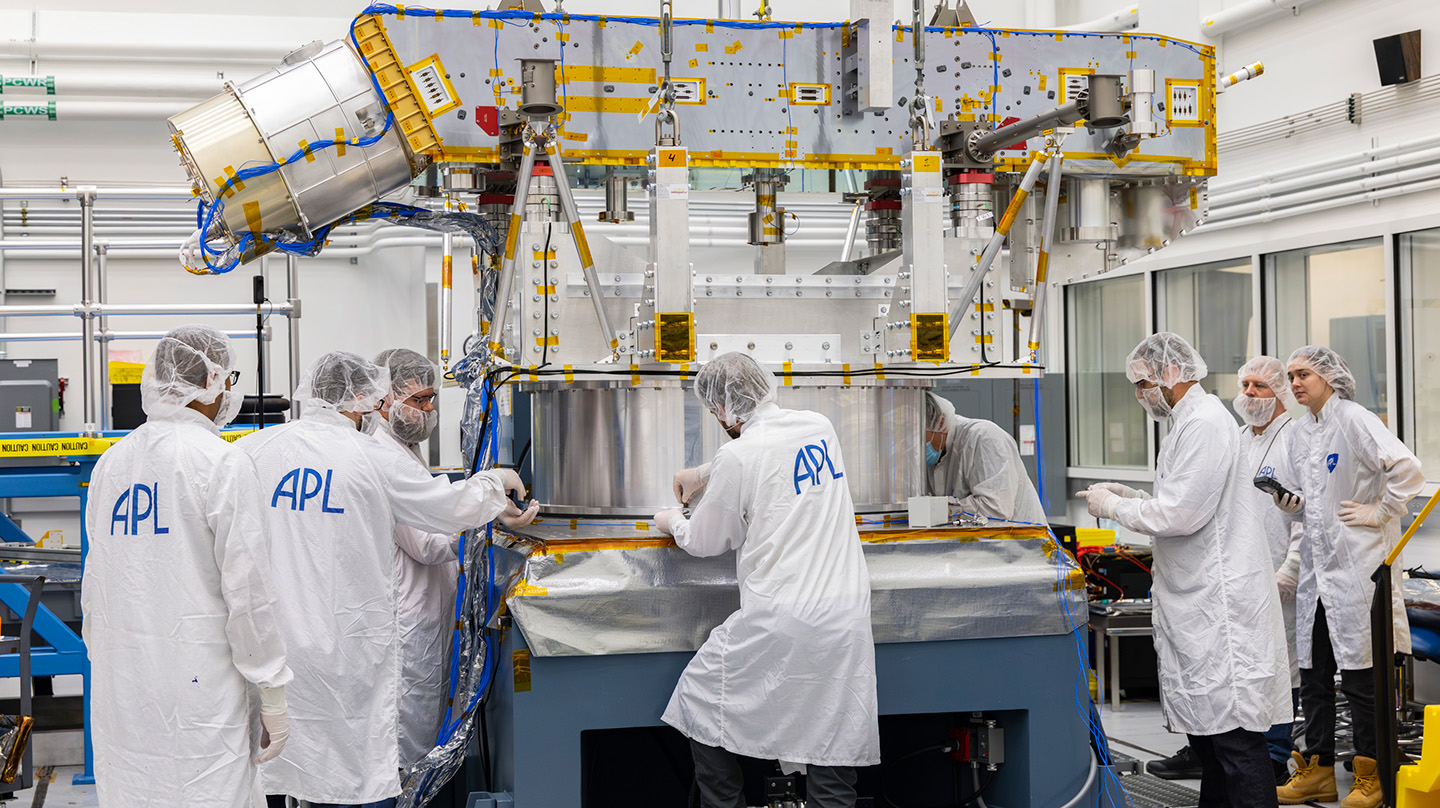 Suspended by four bungee cords, the Dragonfly structure is positioned inches above the floor during ground vibration tests in one of APL’s clean rooms.