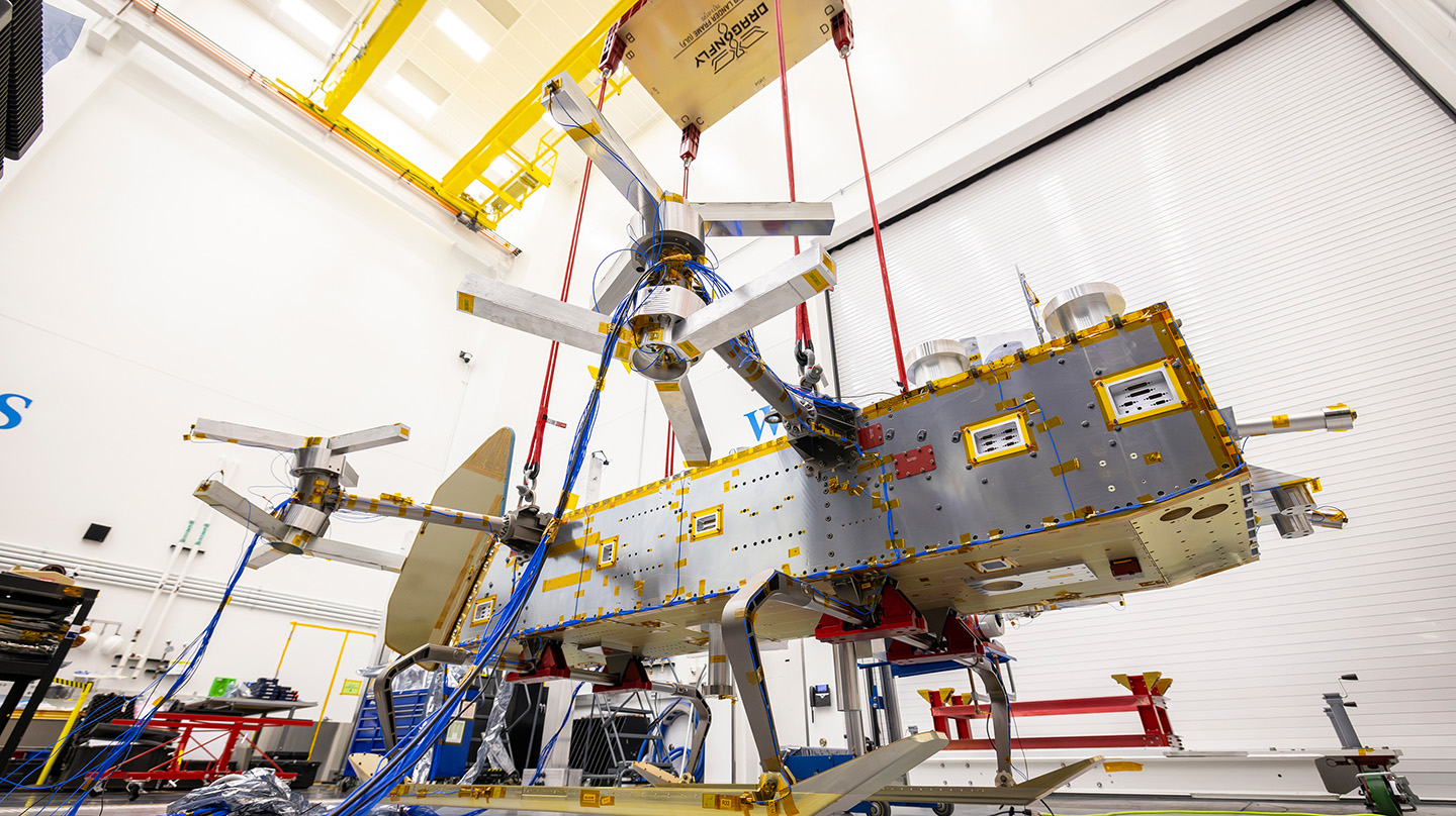 Suspended by four bungee cords, the Dragonfly structure is positioned inches above the floor during ground vibration tests in one of APL’s clean rooms