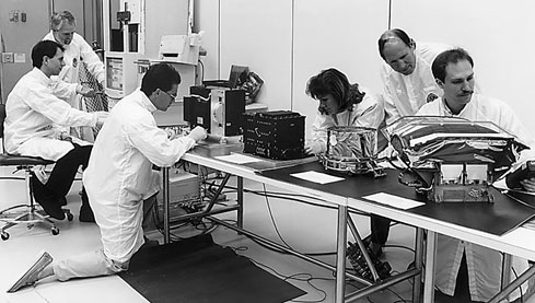 MIMI team members make final inspections of sensors prior to their integration with the Cassini spacecraft