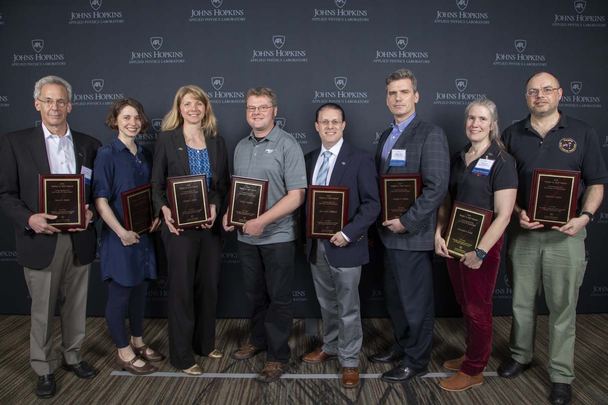 From left to right are Peter D. Bedini, Shannon M. MacKenzie, Kristin S. Sotzen, Colin Z. Sheldon, Kenneth E. Hibbard, Douglas S. Adams, Elizabeth P. Turtle and Ralph D. Lorenz.