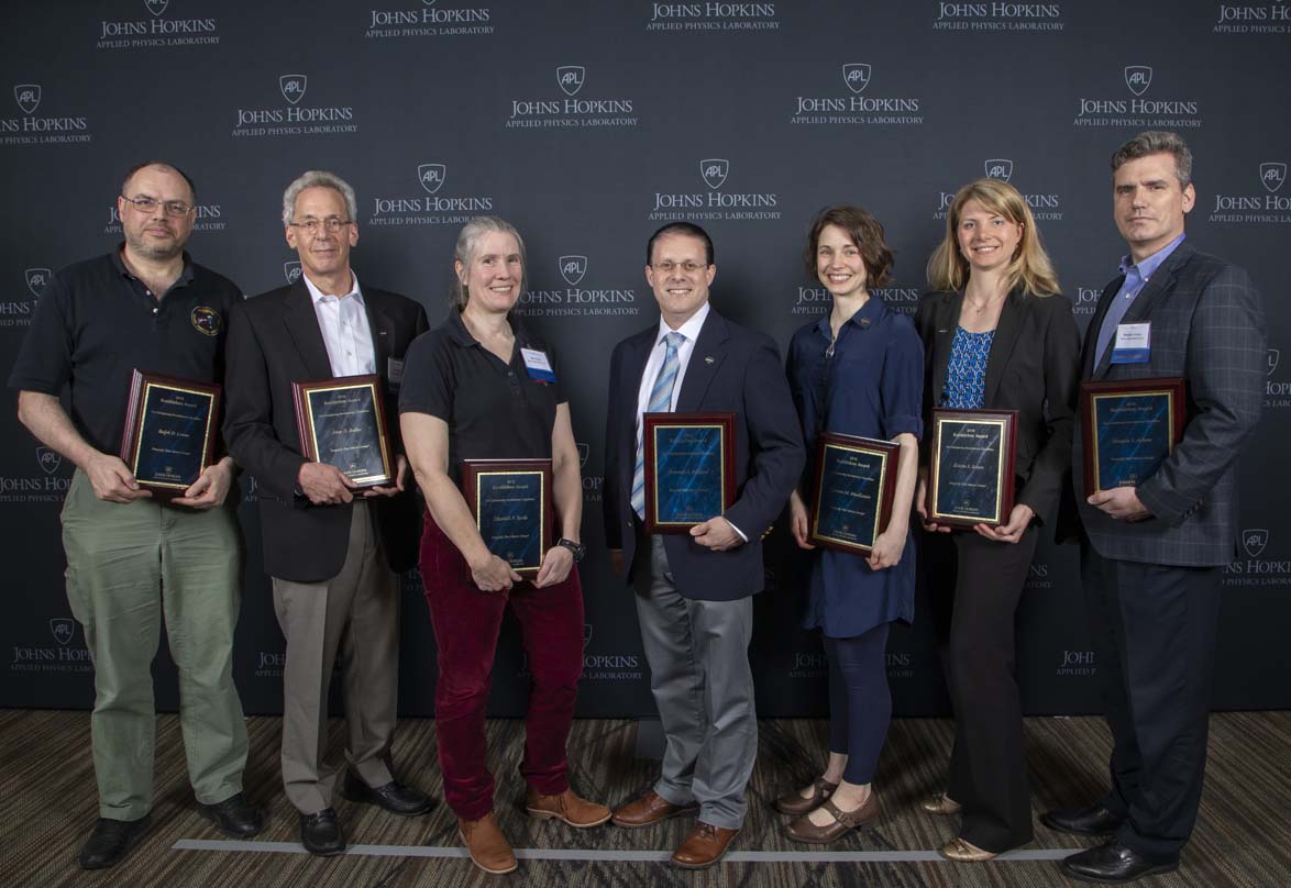 From left to right are Ralph D. Lorenz, Peter D. Bedini, Elizabeth P. Turtle, Kenneth E. Hibbard, Shannon M. MacKenzie, Kristin S. Sotzen and Douglas S. Adams.