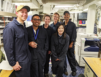 Abraham Edens, left, poses with other scientists and engineers aboard the USS Stockdale (DDG-106) at sea.