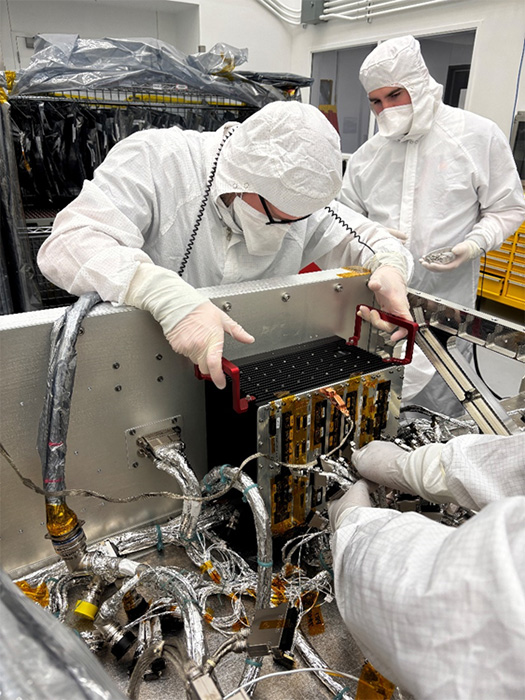  Emory Toomey (left) and Hunter Reeling integrate the engineering model of Dragonfly’s Integrated Electronics Module