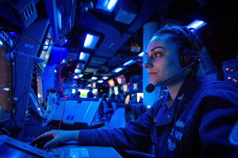 U.S. Navy Operations Specialist 2nd Class Olivia Quinci, from San Diego, California, monitors aircraft aboard the Ticonderoga-class guided-missile cruiser USS Bunker Hill