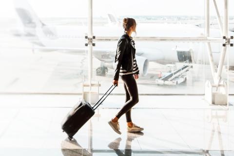 Woman walking through airport terminal